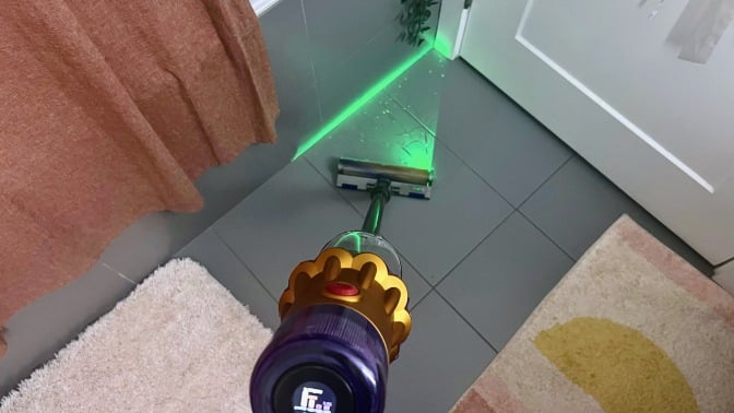 Dyson V12 Detect Slim cleaning bathroom floor with green laser