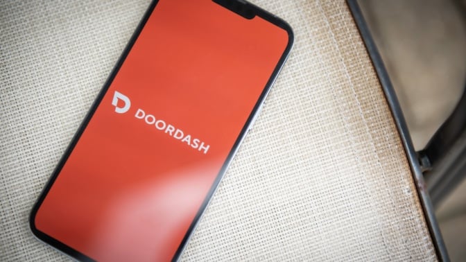 phone with doordash app open sitting on chair