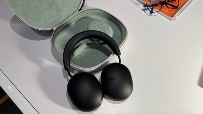 the Sonos Ace headphones laying on a table with their case
