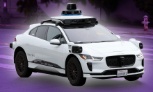 A Waymo car driving on the street.