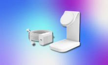 A white Otterbox MagSafe charging station with a detached white power adapter and coiled cable, all against a blue, purple, and pink gradient background.