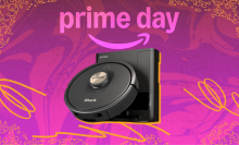 Shark robot vacuum arranged on swirly pink and yellow Prime Day themed backdrop
