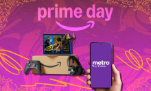 Amazon Prime box and purchases beside hand holding phone with T-Mobile logo on screen, arranged on purple backdrop