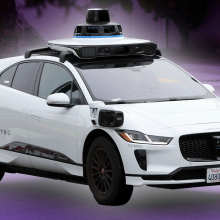 A Waymo car driving on the street.