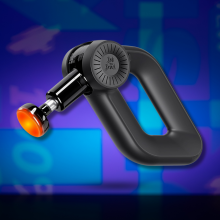 A black Bob and Brad D6 Pro massage gun with an orange, glowing heated massage head is angled to the left against an abstract blue and purple background.