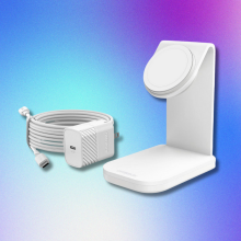 A white Otterbox MagSafe charging station with a detached white power adapter and coiled cable, all against a blue, purple, and pink gradient background.