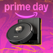 Shark robot vacuum arranged on swirly pink and yellow Prime Day themed backdrop