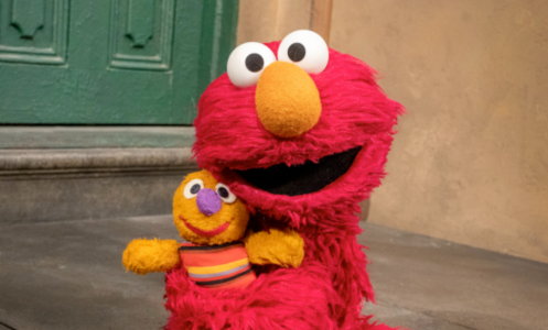 Elmo from 'Sesame Street' hugging a doll.