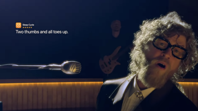 screenshot of a guy singing with translucent glasses